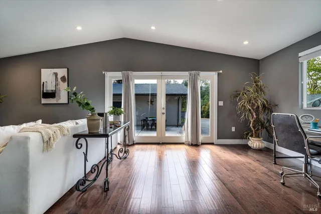 a spacious bedroom with a bed and a chandelier