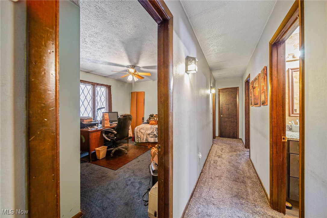 12430 Butternut Road Chardon, OH 44024 - Photo 18 of 33 Hallway with light colored carpet and a textured ceiling
