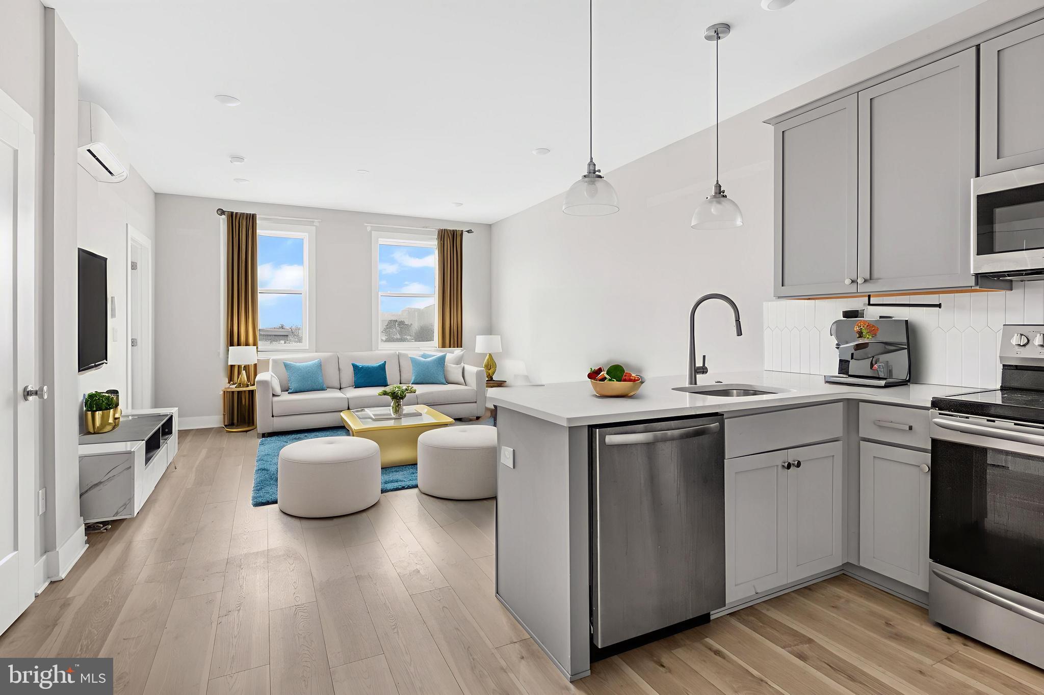 a view of kitchen with stainless steel appliances granite countertop a sink dishwasher stove and refrigerator with wooden floor