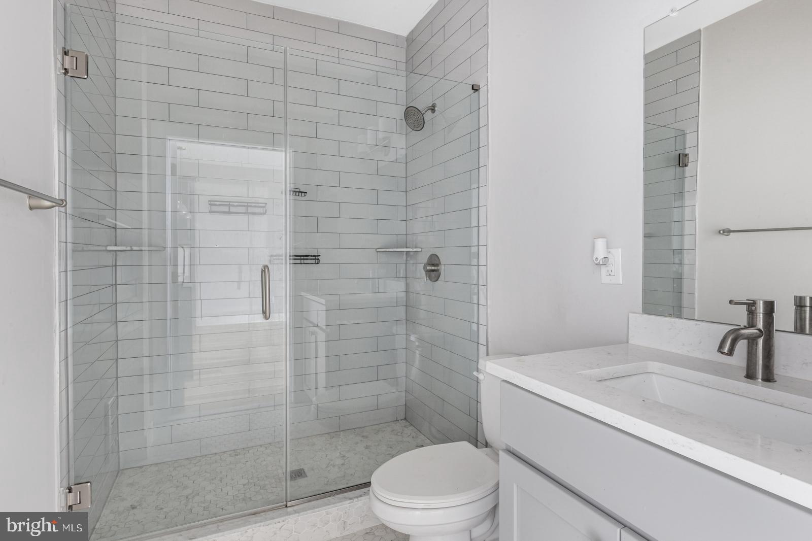 5230 Walnut Street, Unit 4R Philadelphia, PA 19139 - Photo 11 of 19 a bathroom with a sink a toilet and shower