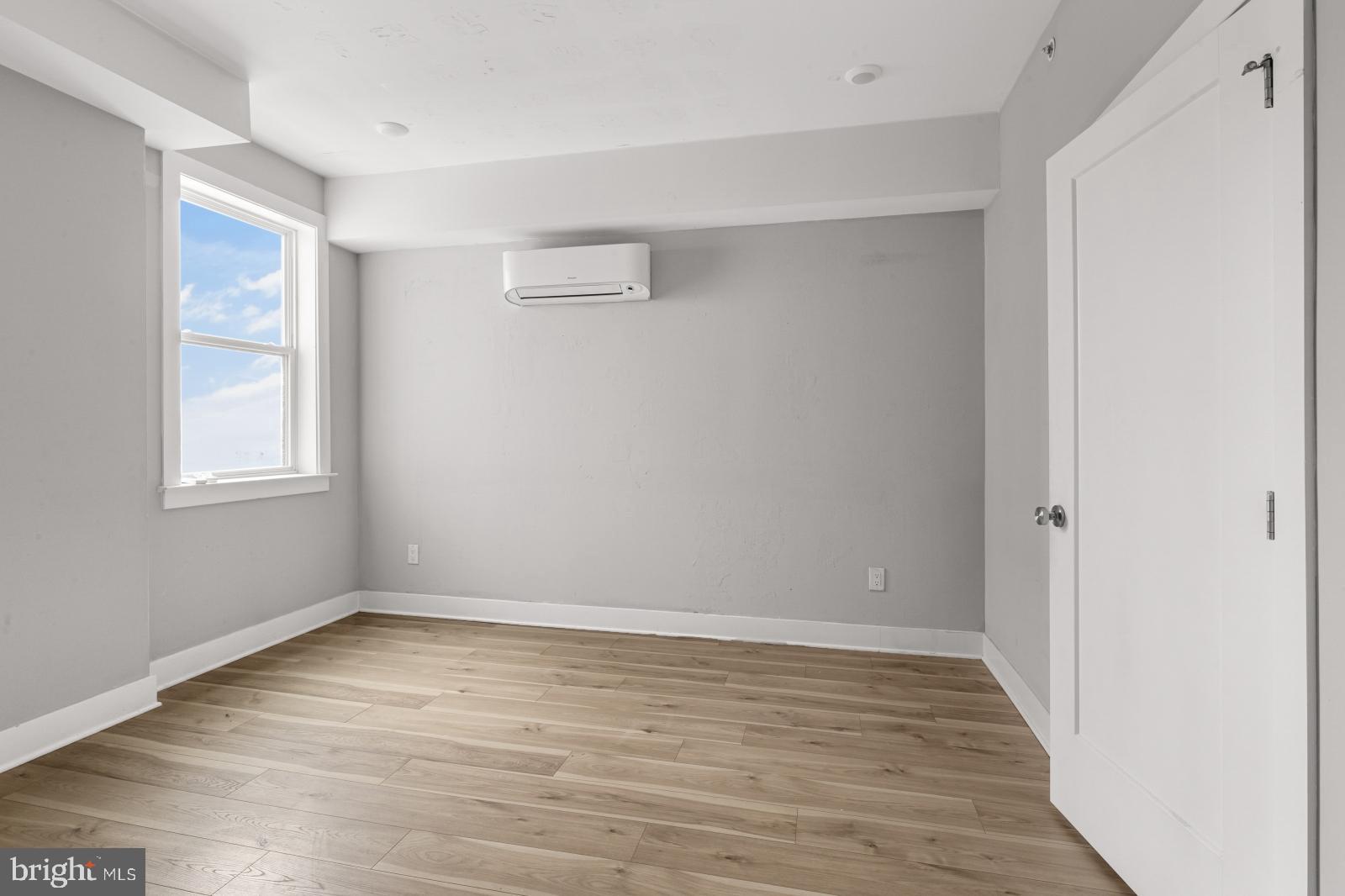 5230 Walnut Street, Unit 4R Philadelphia, PA 19139 - Photo 12 of 19 wooden floor in an empty room with a window