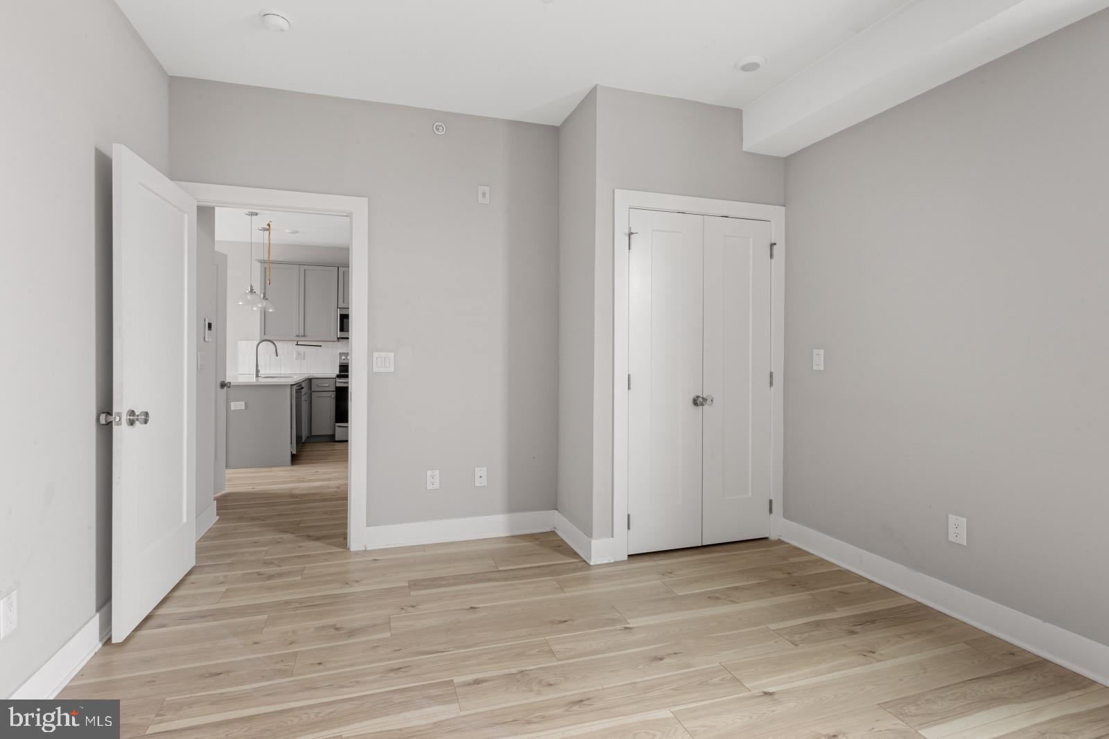 5230 Walnut Street, Unit 4R Philadelphia, PA 19139 - Photo 13 of 19 a view of a hallway with wooden floor and a bathroom