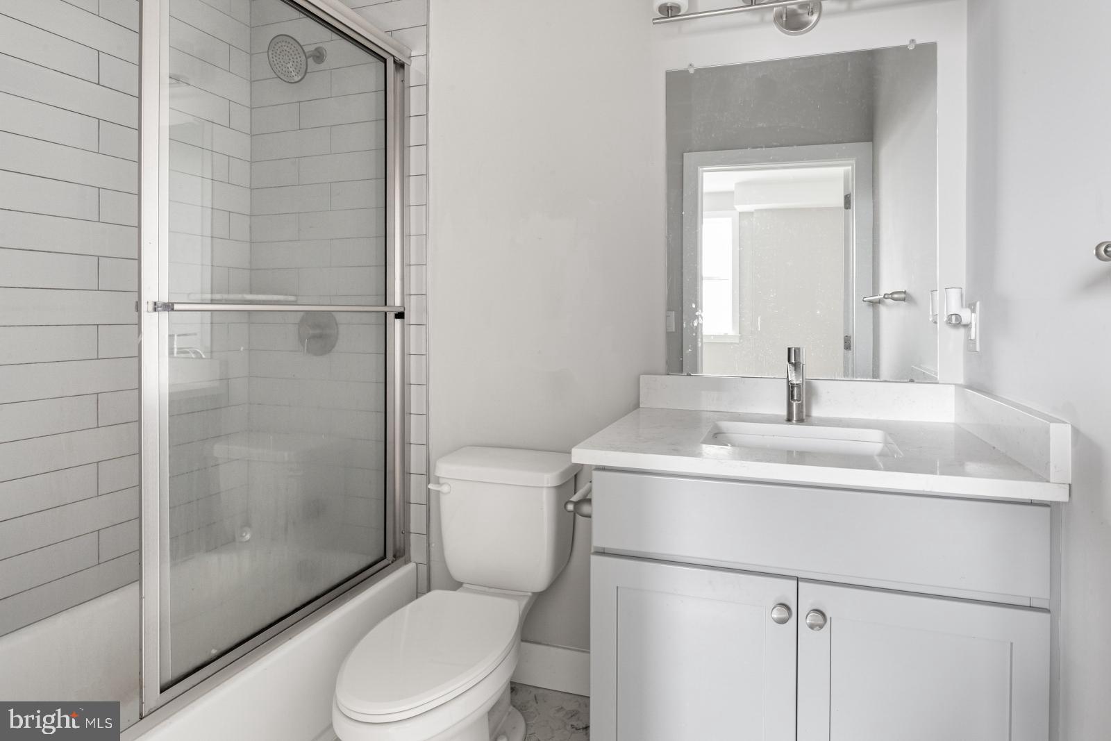5230 Walnut Street, Unit 4R Philadelphia, PA 19139 - Photo 15 of 19 a bathroom with a sink toilet and shower