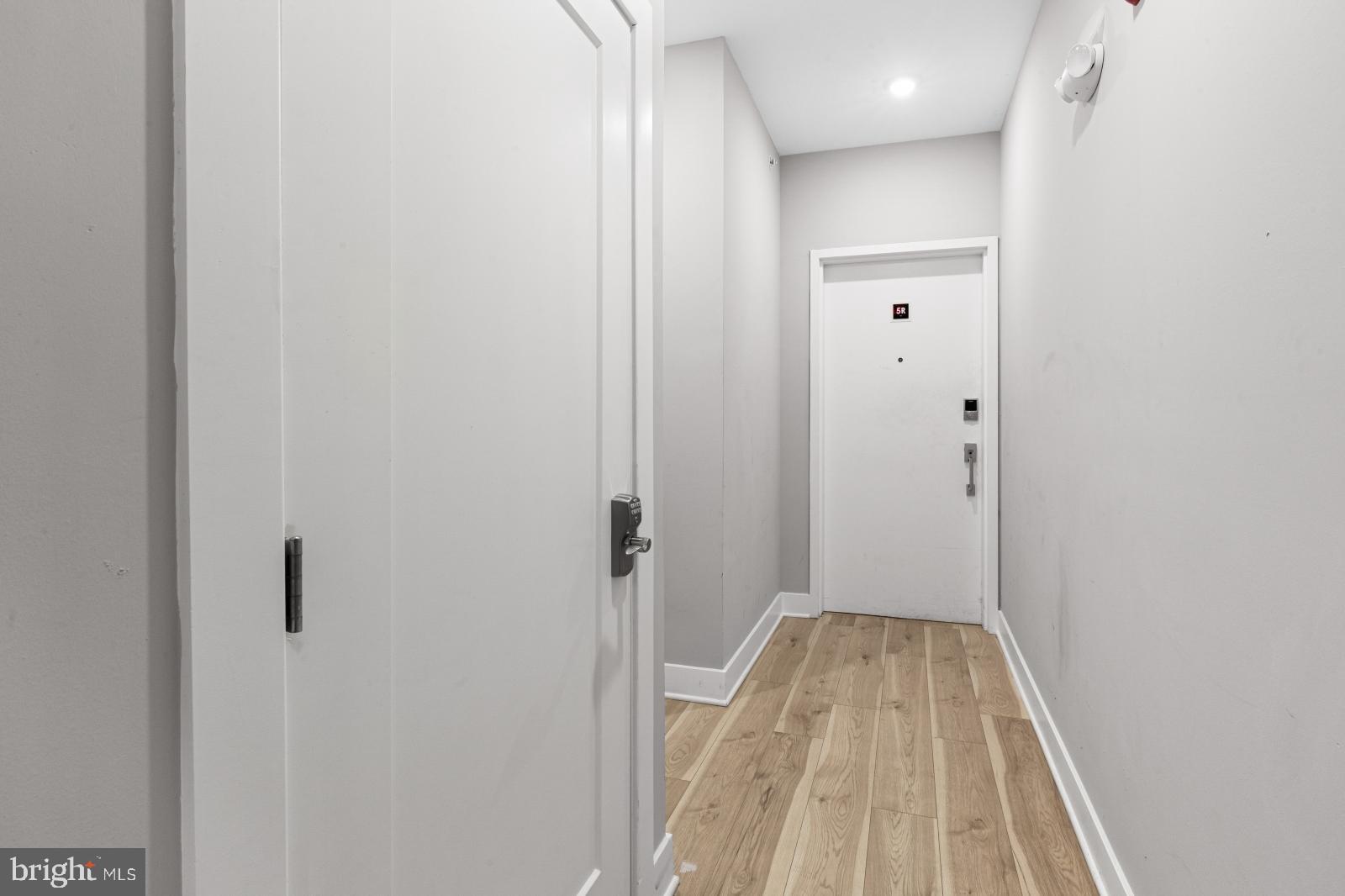 5230 Walnut Street, Unit 4R Philadelphia, PA 19139 - Photo 16 of 19 a view of a hallway with wooden floor and a bathroom