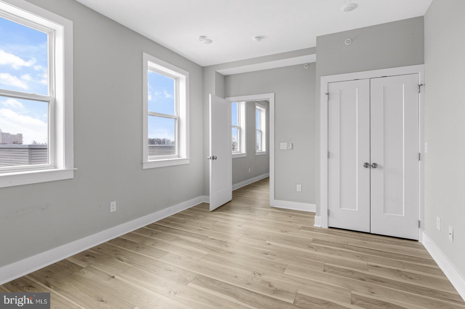 5230 Walnut Street, Unit 4R Philadelphia, PA 19139 - Photo 10 of 19 a view of an empty room with wooden floor and a window