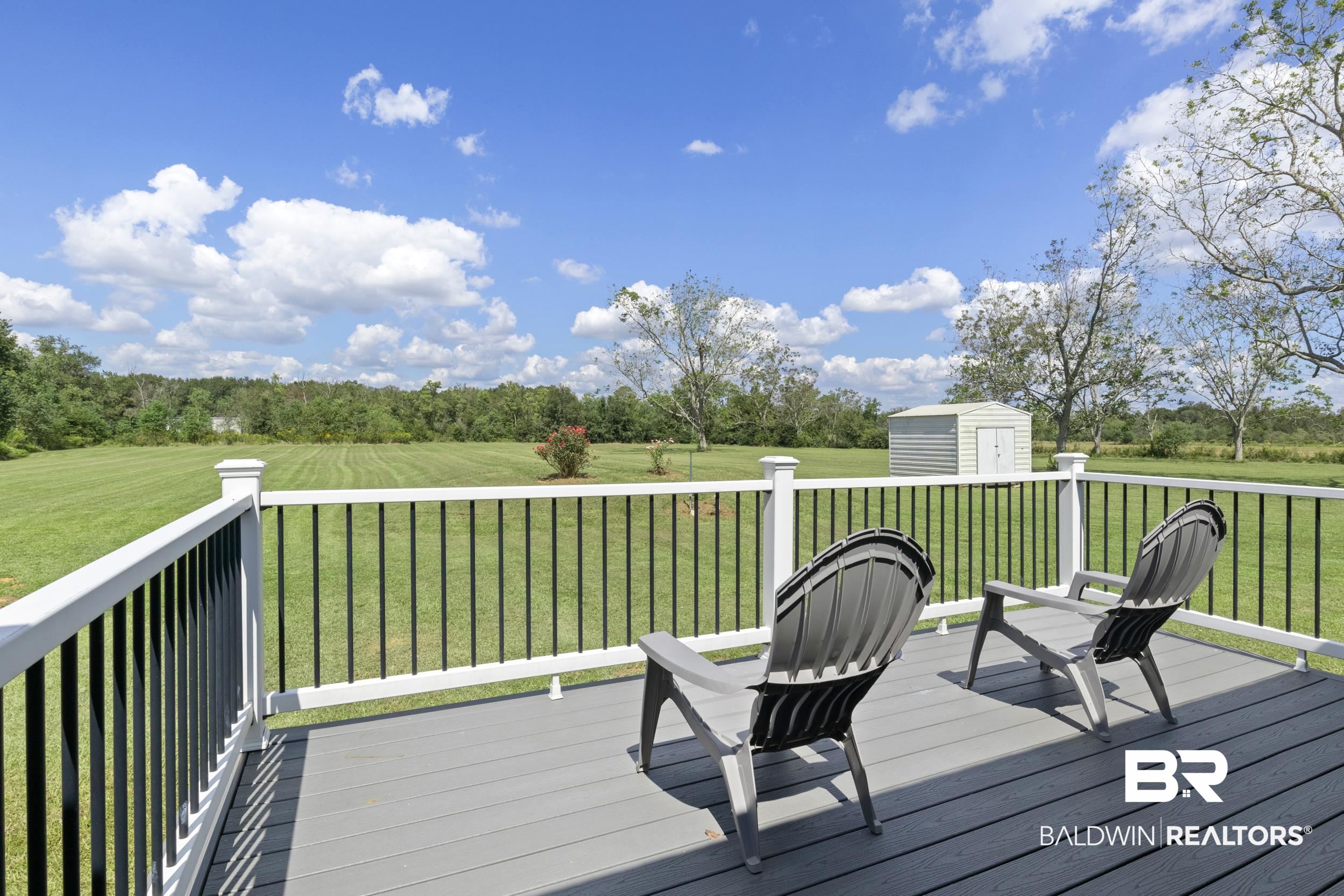 17689 Brewer Road Foley, AL 36535 - Photo 7 of 54 Wooden deck with a storage shed and a yard