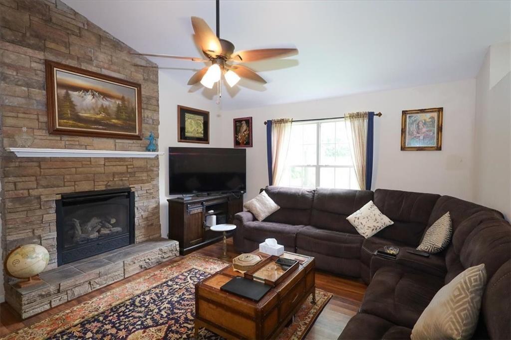 236 Hiram Sudie Road Dallas, GA 30157 - Photo 5 of 26 a living room with furniture a flat screen tv and a fireplace