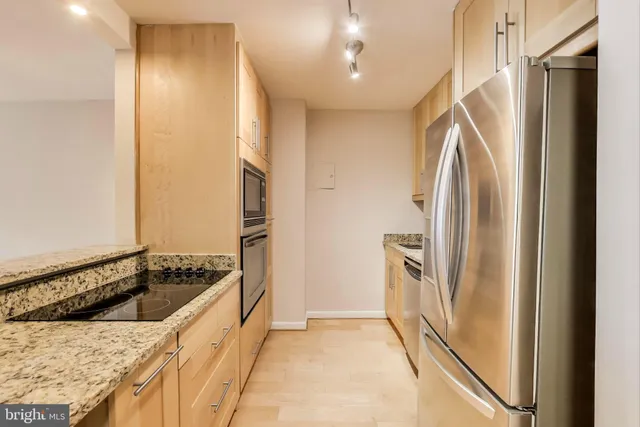 a kitchen with a sink cabinets and utility room