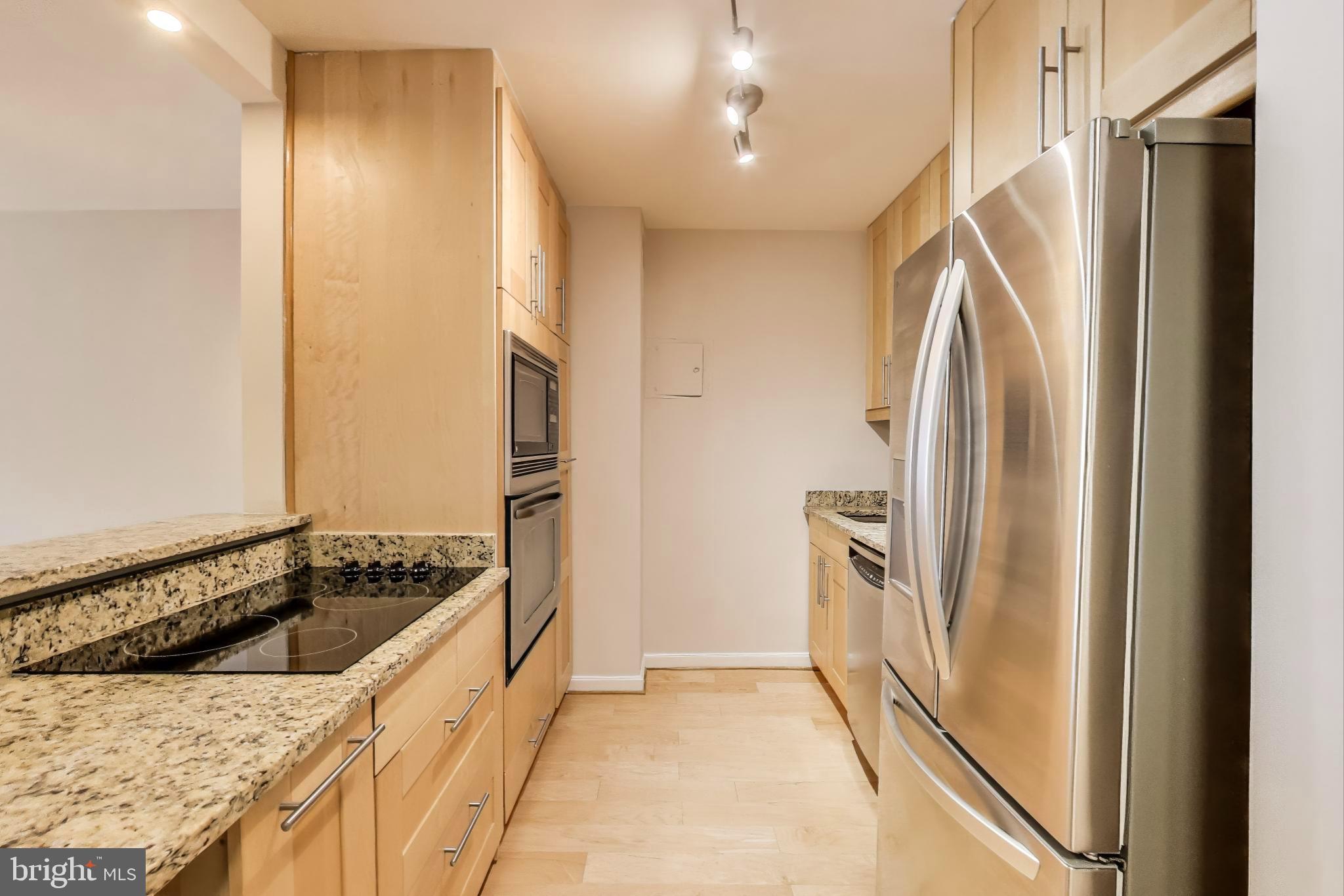 1435 4th Street Southwest, Unit B609 Washington, DC 20024 - Photo 12 of 28 a kitchen with a refrigerator and a stove