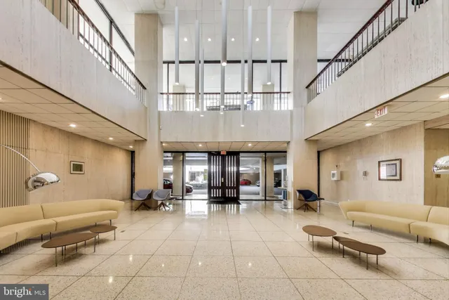 a lobby with furniture and a potted plant