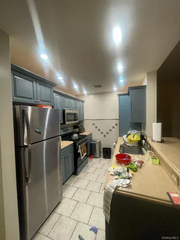 a kitchen with refrigerator a microwave and a sink