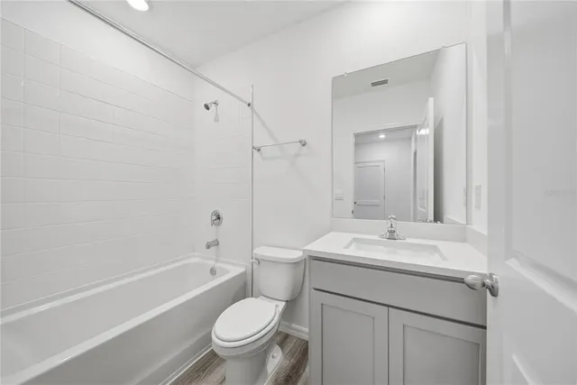 an aerial view of residential houses with outdoor space and lake view