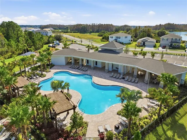a view of a swimming pool with an outdoor seating