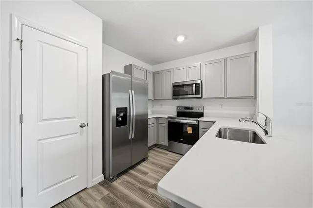 a kitchen with a refrigerator sink and microwave