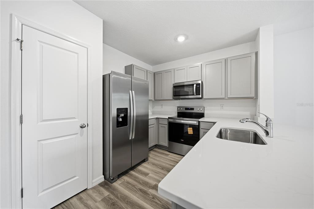 32497 Midsummer Night Lane Wesley Chapel, FL 33543 - Photo 7 of 30 a kitchen with a refrigerator sink and microwave