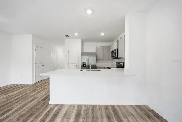 a view of kitchen with wooden floor