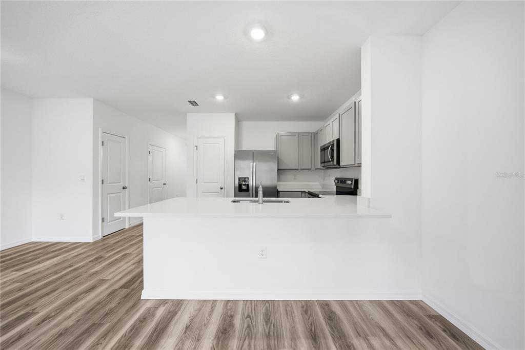 32497 Midsummer Night Lane Wesley Chapel, FL 33543 - Photo 8 of 30 a view of kitchen with wooden floor