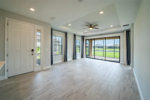 a kitchen with stainless steel appliances granite countertop white cabinets a refrigerator and a stove