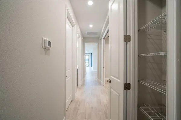 a large kitchen with stainless steel appliances granite countertop a refrigerator and a stove top oven