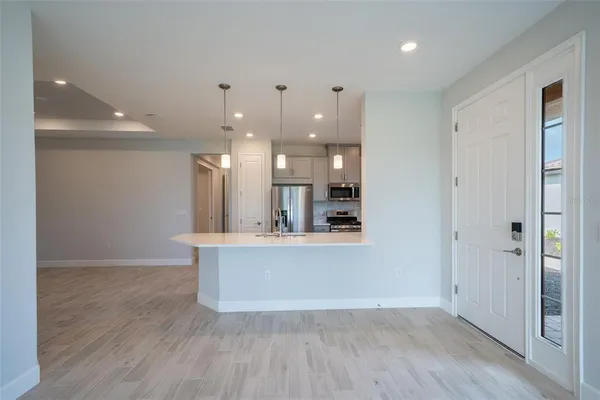 a view of an empty room and a bathroom