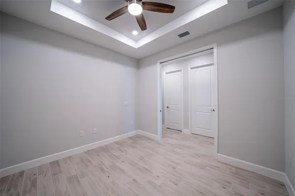 an empty room with a empty space and a ceiling fan