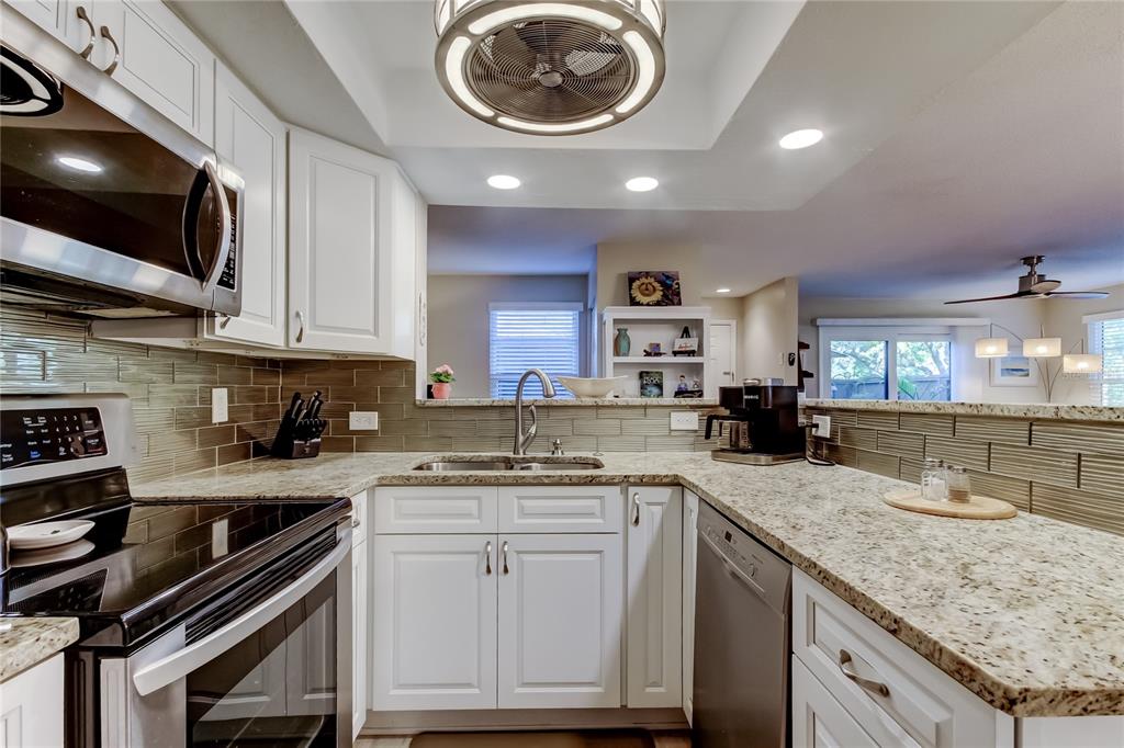 1407 Lennox Road East, Unit 1407 Palm Harbor, FL 34683 - Photo 16 of 48 a kitchen with a sink cabinets and stainless steel appliances