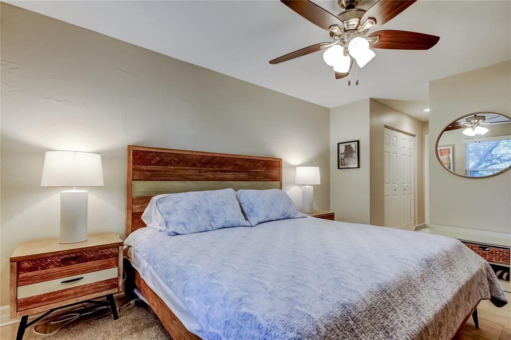 1407 Lennox Road East, Unit 1407 Palm Harbor, FL 34683 - Photo 25 of 48 a bedroom with a bed and a chandelier