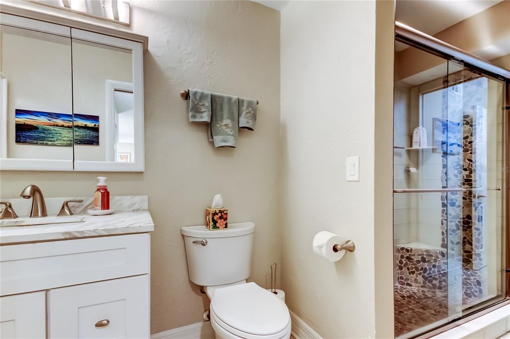 1407 Lennox Road East, Unit 1407 Palm Harbor, FL 34683 - Photo 29 of 48 a bathroom with a toilet sink and shower