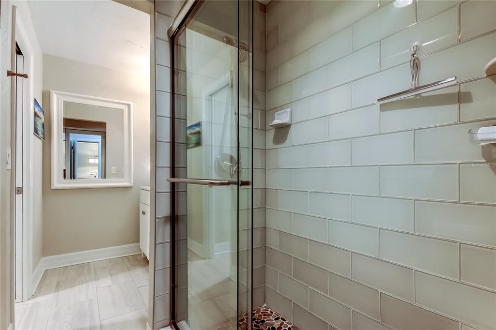 1407 Lennox Road East, Unit 1407 Palm Harbor, FL 34683 - Photo 30 of 48 a bathroom with a glass shower door