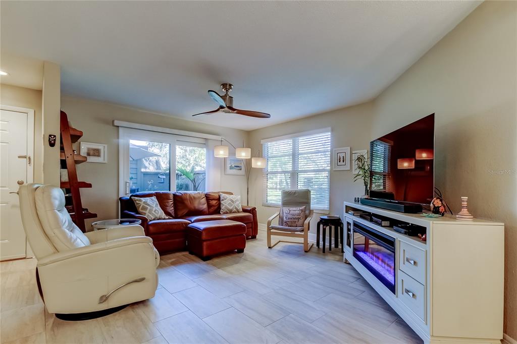1407 Lennox Road East, Unit 1407 Palm Harbor, FL 34683 - Photo 3 of 48 a living room with furniture and a flat screen tv