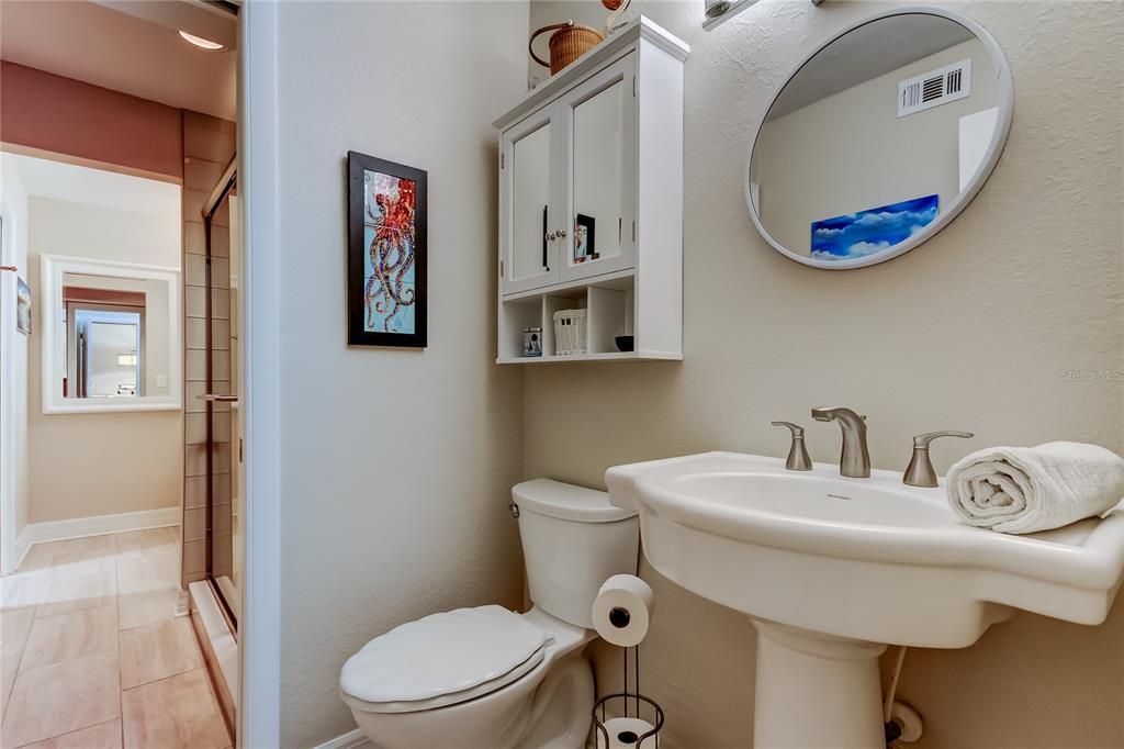 1407 Lennox Road East, Unit 1407 Palm Harbor, FL 34683 - Photo 32 of 48 a bathroom with a sink mirror and toilet