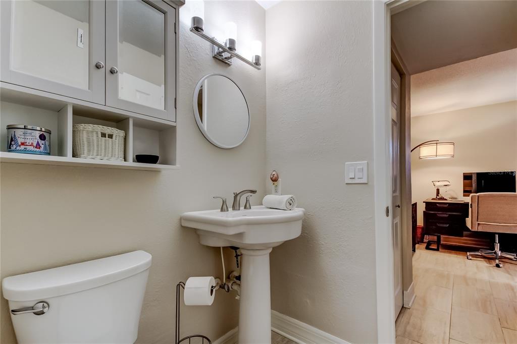 1407 Lennox Road East, Unit 1407 Palm Harbor, FL 34683 - Photo 33 of 48 a bathroom with a sink a mirror and toilet