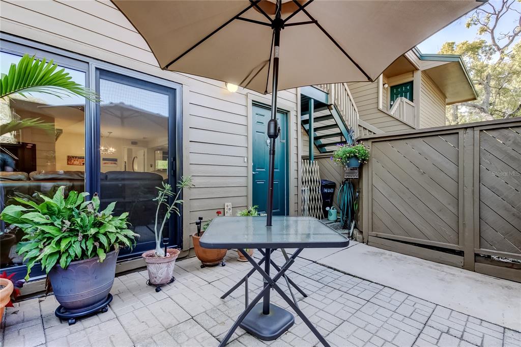 1407 Lennox Road East, Unit 1407 Palm Harbor, FL 34683 - Photo 40 of 48 a view of a chairs and table in the patio