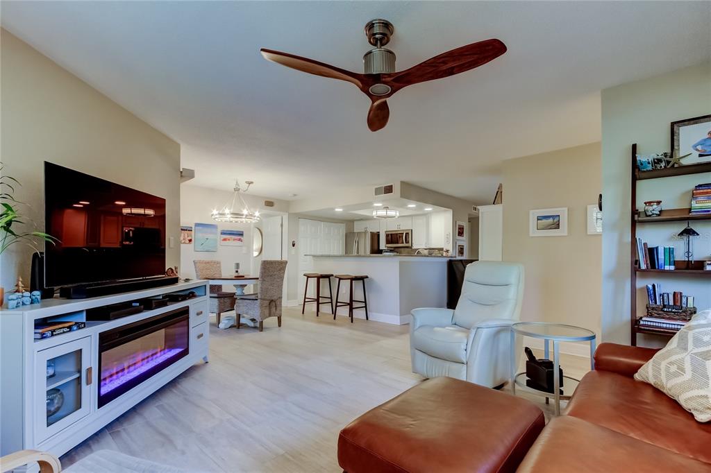 1407 Lennox Road East, Unit 1407 Palm Harbor, FL 34683 - Photo 4 of 48 a living room with furniture and a flat screen tv