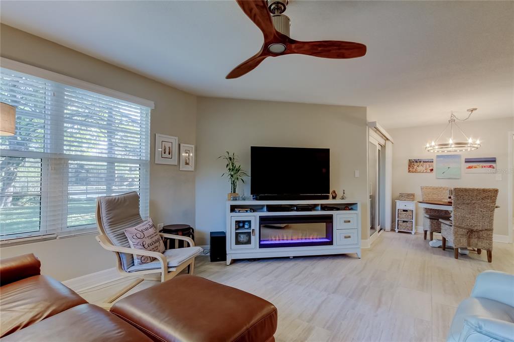 1407 Lennox Road East, Unit 1407 Palm Harbor, FL 34683 - Photo 5 of 48 a living room with furniture and a flat screen tv