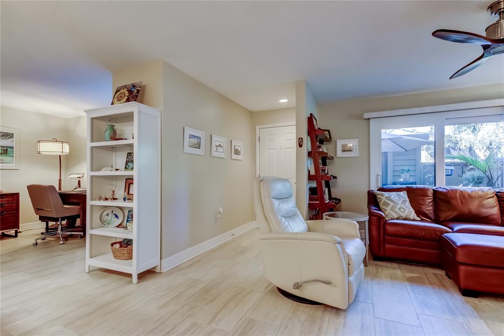 1407 Lennox Road East, Unit 1407 Palm Harbor, FL 34683 - Photo 10 of 48 a living room with furniture and a book shelf