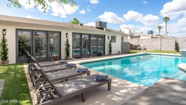 a view of a swimming pool with sitting area