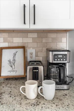 a view of a dining room with furniture and a potted plant