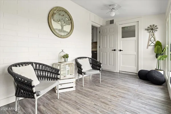 a view of a backyard with couches chair and wooden floor