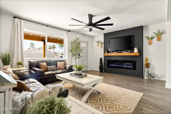 a kitchen with stainless steel appliances granite countertop a refrigerator a sink and white cabinets