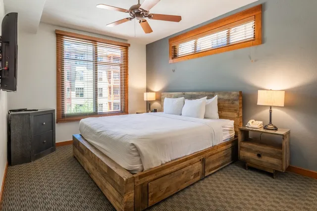 a bed room with a bed and a chandelier