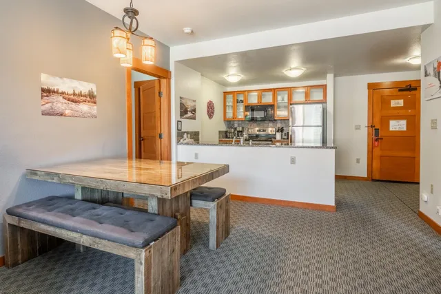 a room with pool table and windows