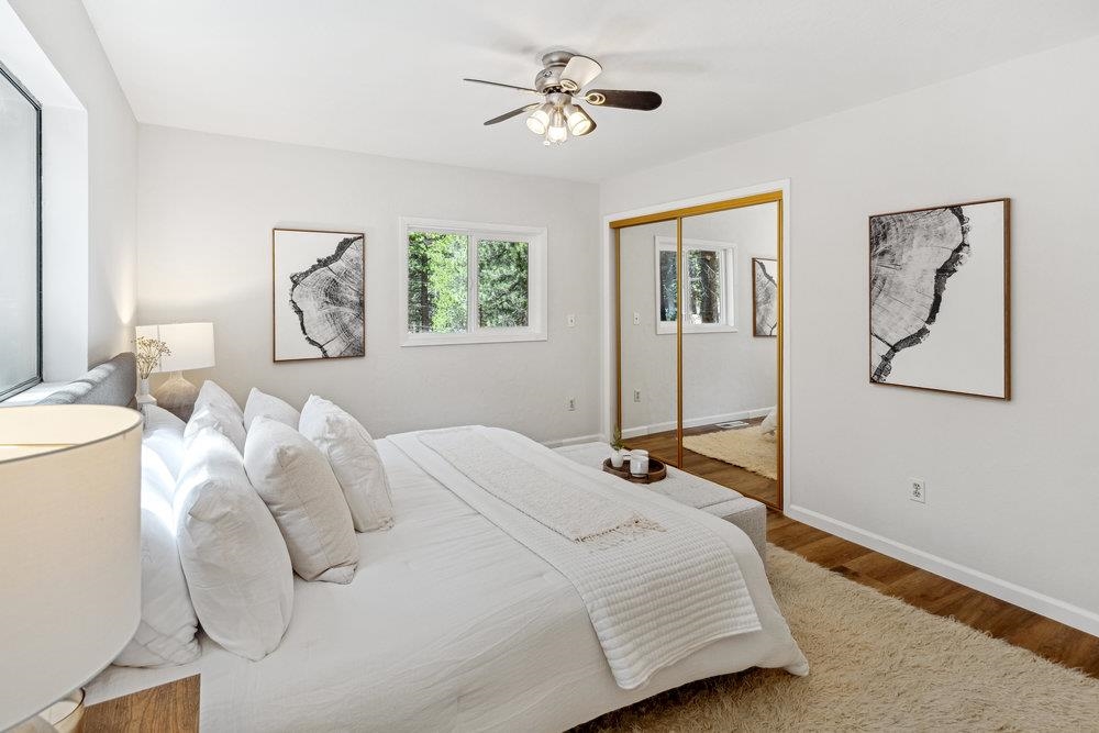 12068 Pine Forest Road Truckee, CA 96161 - Photo 13 of 27 a bedroom with a bed and a chandelier