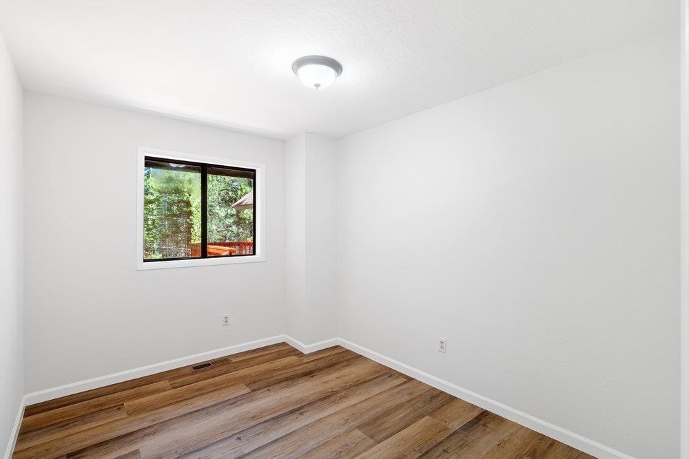 12068 Pine Forest Road Truckee, CA 96161 - Photo 16 of 27 a view of small space with wooden floor and a window