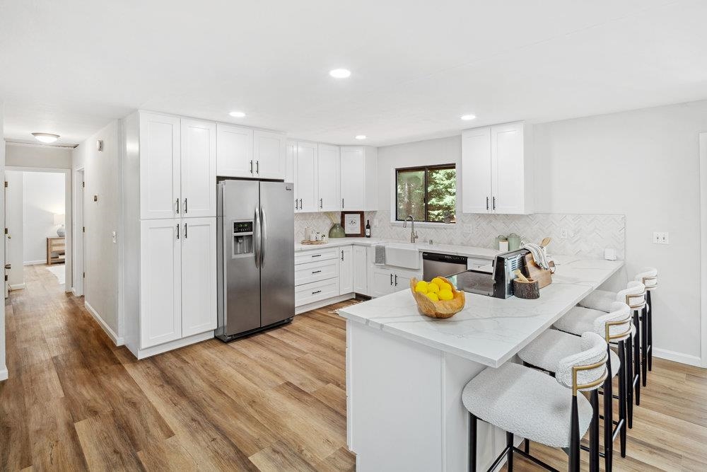 12068 Pine Forest Road Truckee, CA 96161 - Photo 4 of 27 a kitchen with a sink a refrigerator and wooden floor