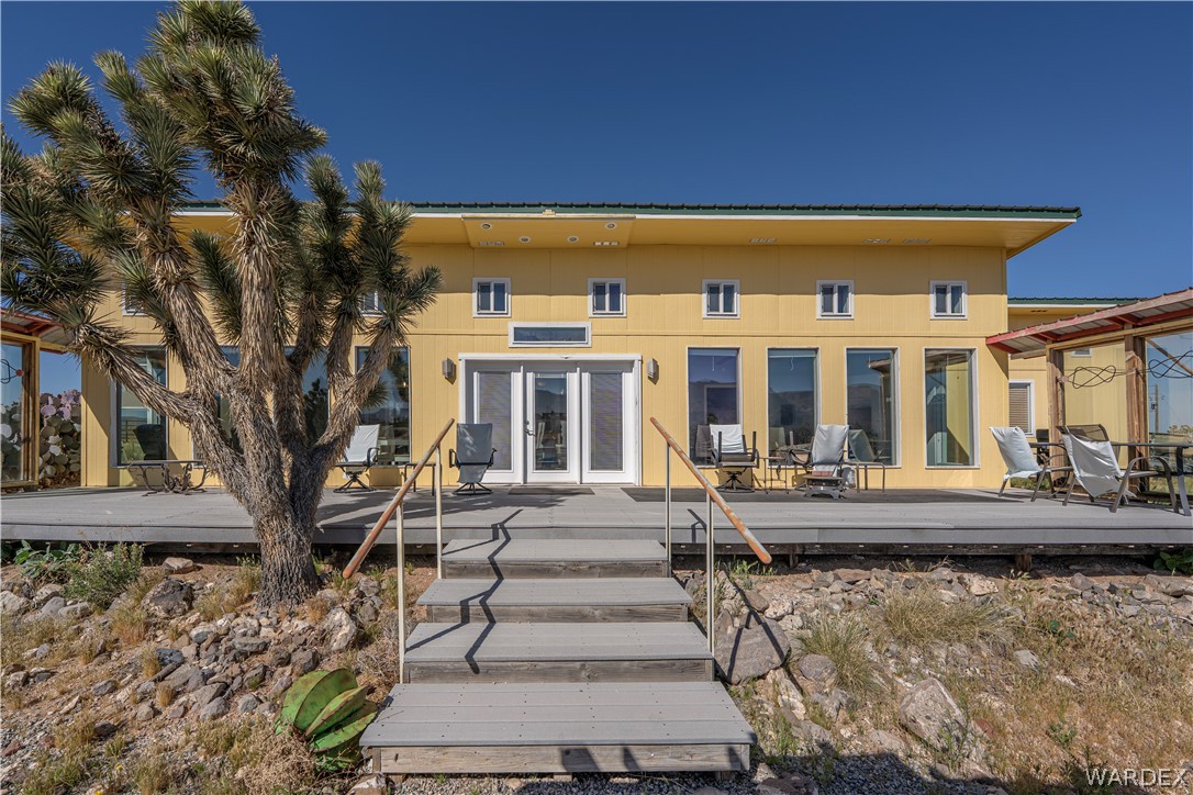 26512 North Yucca Road Meadview, AZ 86444 - Photo 12 of 38 The property features a spacious exterior deck with visible large windows and glass doors, offering an abundance of natural light