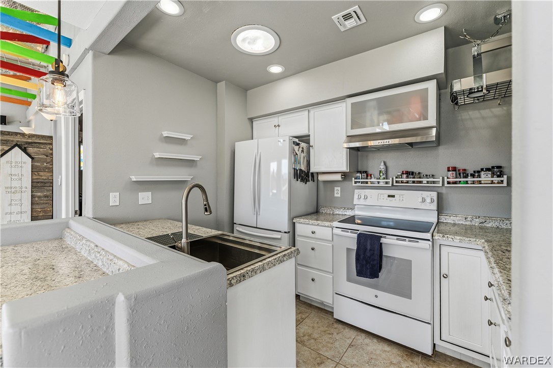 26512 North Yucca Road Meadview, AZ 86444 - Photo 19 of 38 The kitchen features white cabinetry, and recessed lighting