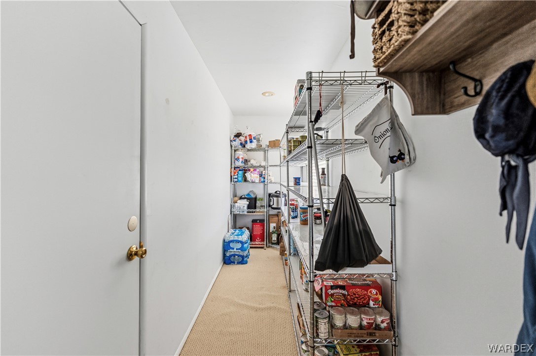 26512 North Yucca Road Meadview, AZ 86444 - Photo 27 of 38 The property features a dedicated pantry area with extensive wire shelving, providing significant storage capacity
