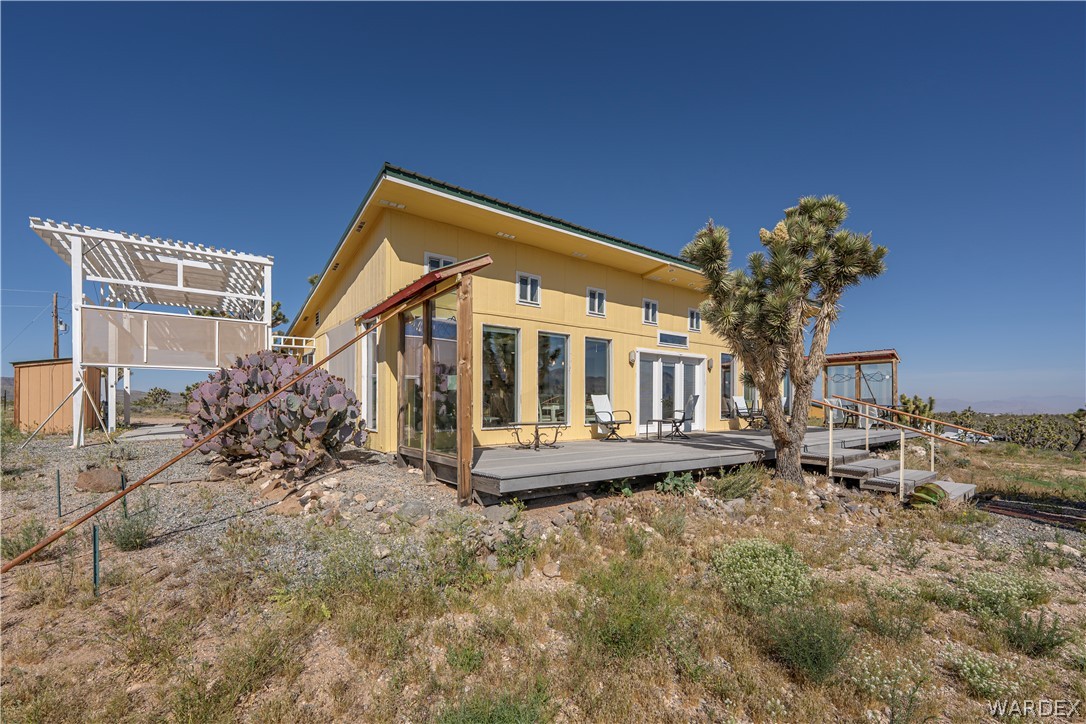 26512 North Yucca Road Meadview, AZ 86444 - Photo 3 of 38 The property features a spacious exterior deck with double doors, large windows.