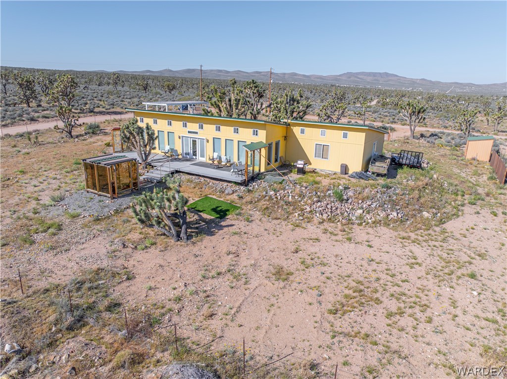26512 North Yucca Road Meadview, AZ 86444 - Photo 4 of 38 The property features a yellow exterior and a spacious outdoor deck, ideal for relaxation